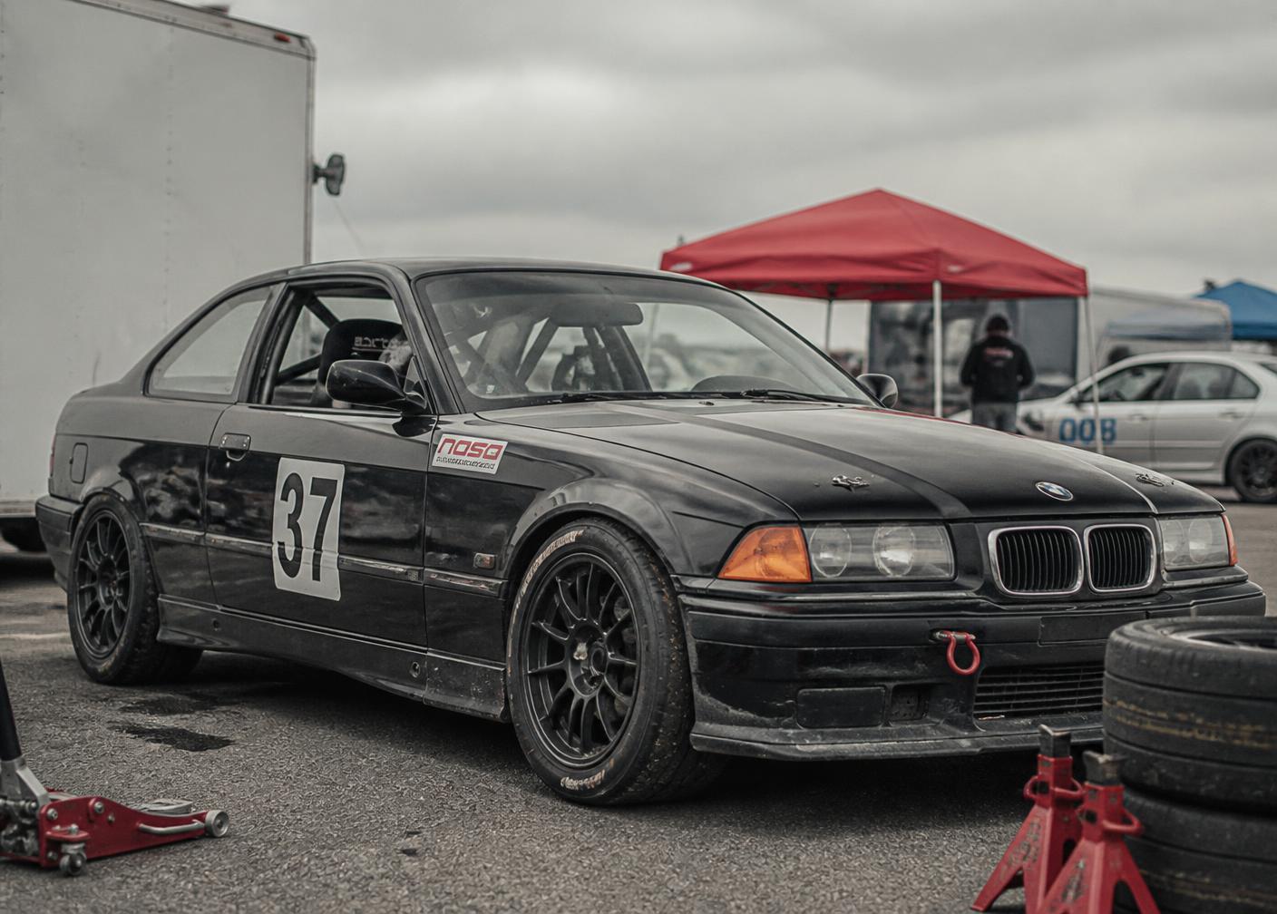 Track-prepared BMW E36 in the paddock
